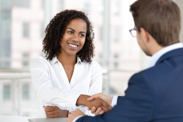 Woman shaking hands with business man